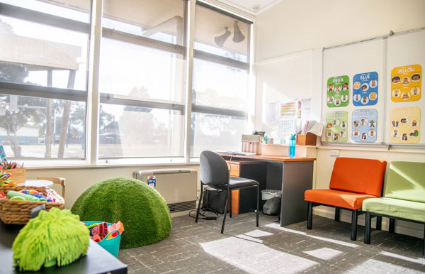 Bright office and learning space at Watsonia North Primary School with desks, seating, and large windows.