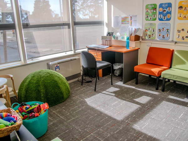 Bright office and learning space at Watsonia North Primary School with desks, seating, and large windows.